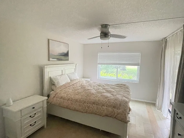 Largest bedroom with private bathroom and sliding glass doors to lanai.