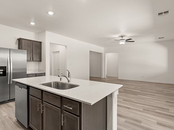 The kitchen seamlessly flows into the spacious living room and the dining area.