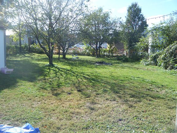 Fenced in Yard with fruit trees and garden and fire pit spac