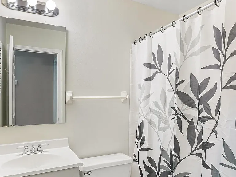 2 of 2 full bathrooms; new showerhead, lighting, and mirror