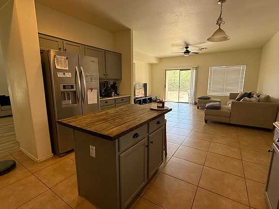 Kitchen looking into family room with slider to outside covered patio.