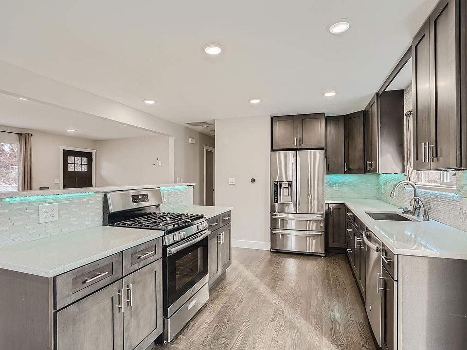 Spacious kitchen with beautiful white quartz countertops, stainless appliances