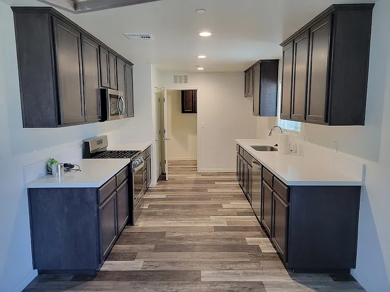 Kitchen. Ample counter space and lots of cabinets for storage.