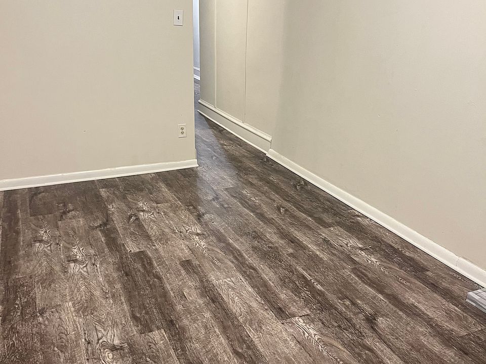Living room and hallway entrance to rest of the apartment