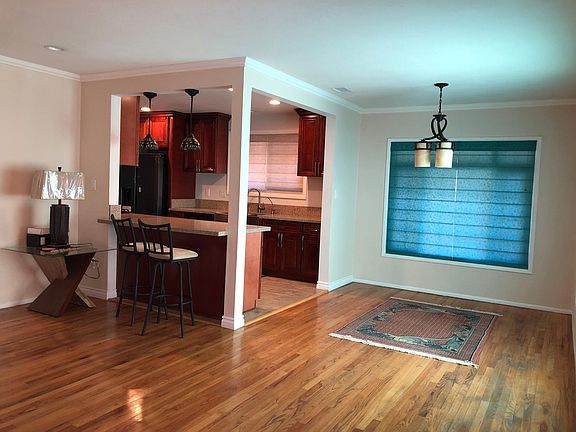 Another view upon entering the house. Mini bar connecting to kitchen. Recessed lighting.