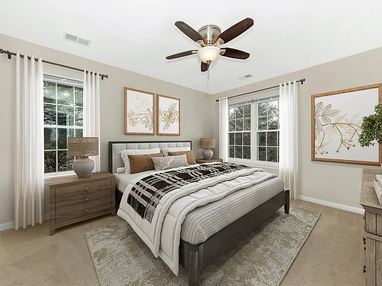 Primary larger bedroom suite staged with furniture.