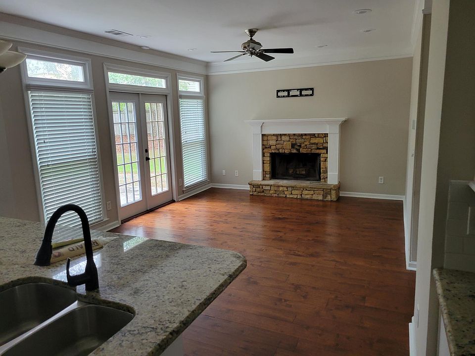 From the Kitchen into the main area for sofas and living. The window/doors open to the back yard.