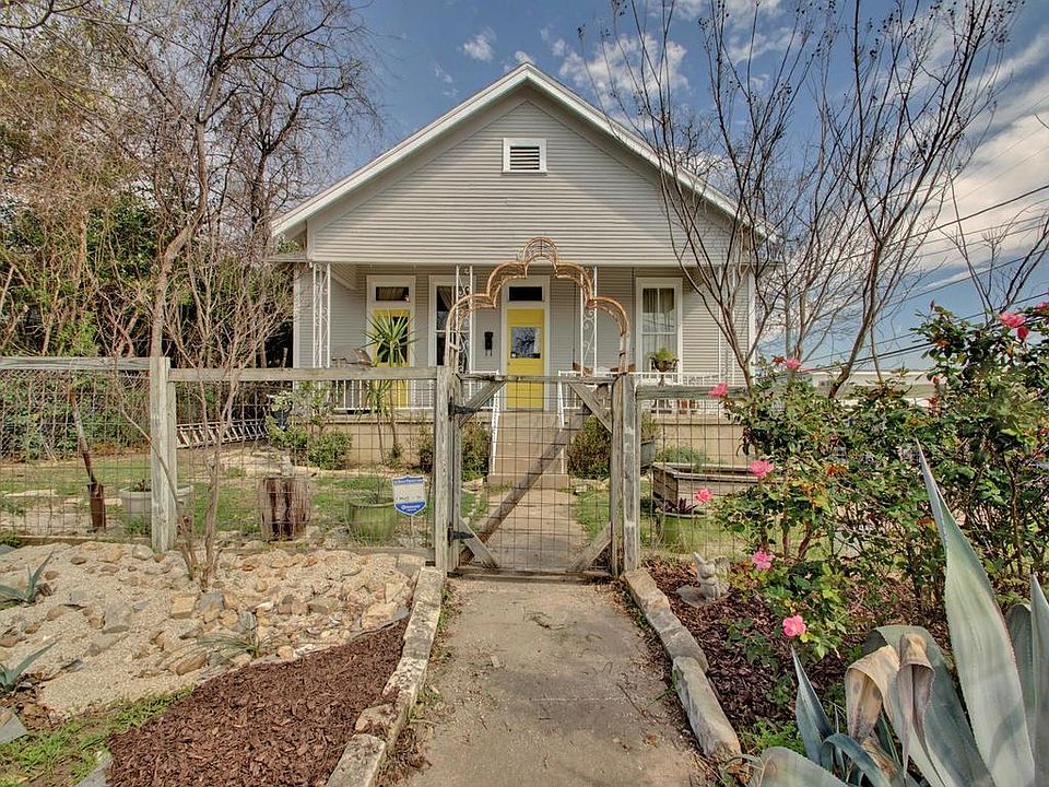 Fenced front yard with beautiful landscaping.