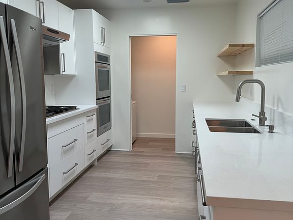 Kitchen with pocket door to Laundry room open