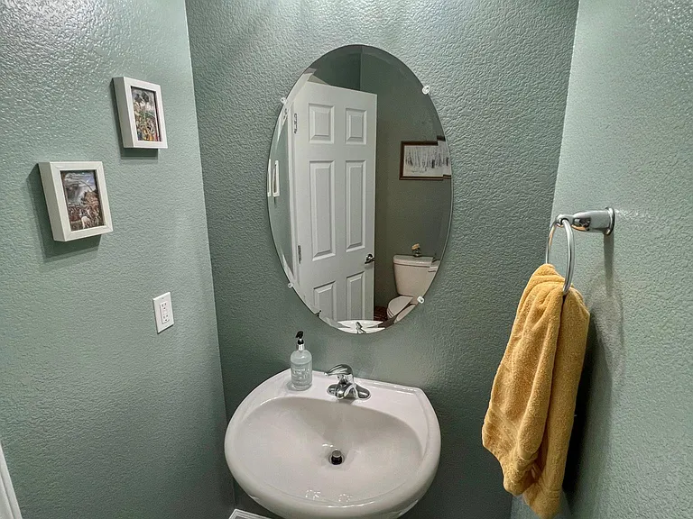 Sink and mirror in half bath.