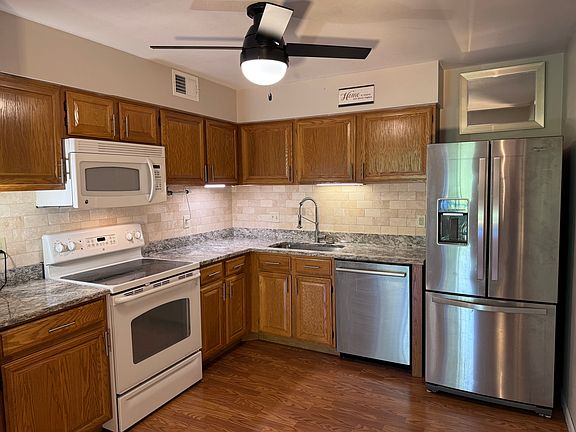 Updated kitchen with granite countertops and ceramic tile backsplash