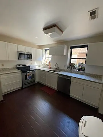 Large, newly renovated kitchen with granite counters. - 5703 Elmer St