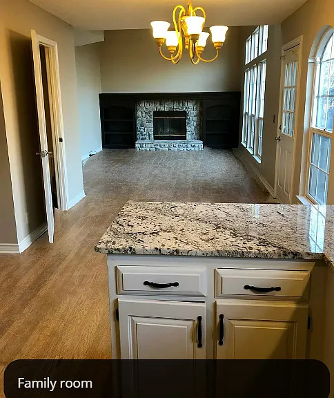 View of dining area & family room from kitchen (the open door is a 1/2 bath)