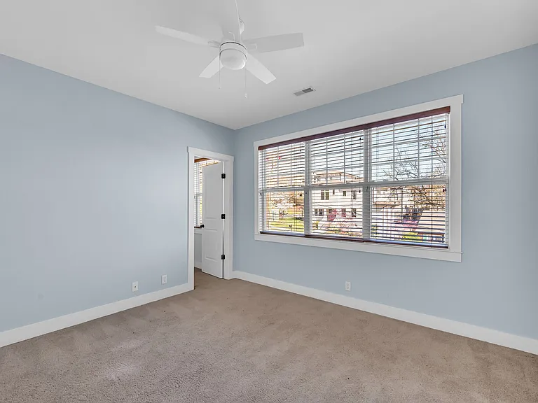 third bedroom at front of home with large windows