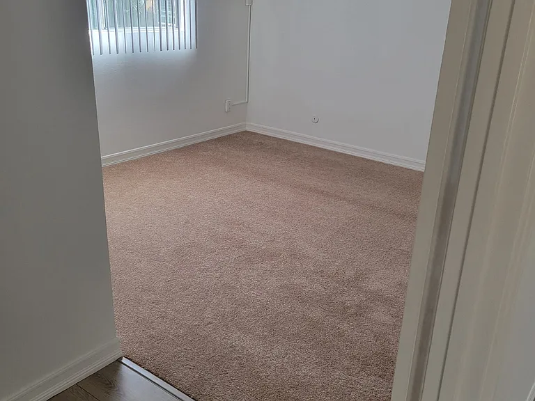 bedroom view from hallway (A/C unit and ceiling fan in photo)