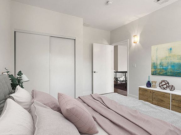 Carpeted bedroom with private closet.