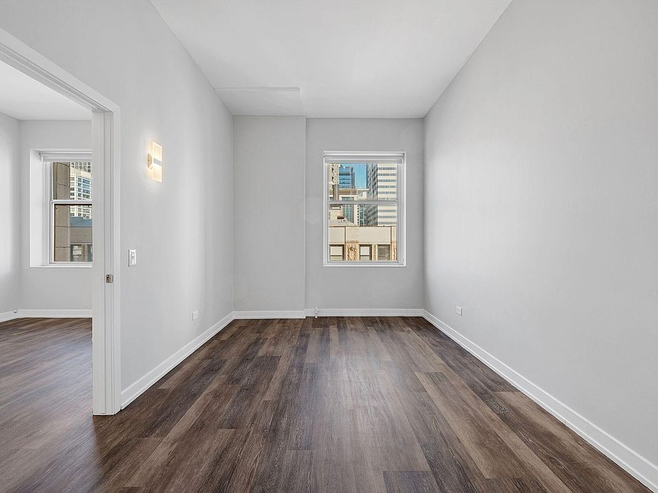 City view from 21st floor bedroom. 12' ceilings, fully remodeled apartments with new flooring, light fixtures and contemporary roller shades covering 8' windows in all apartments.