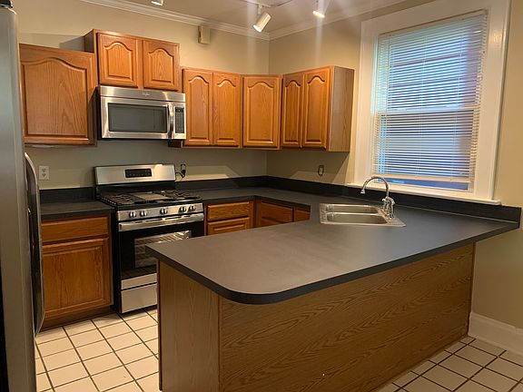 Kitchen with new sink and stove. Also has dishwasher and microwave and side by side refrigerator.