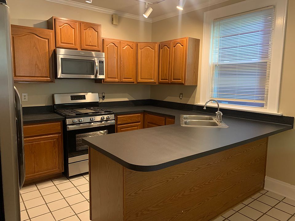 Kitchen with new sink and stove. Also has dishwasher and microwave and side by side refrigerator.