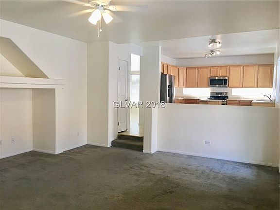 View from the family room up to the kitchen and dinette area.  Notice the new updated lighting installed in the kitchen specific