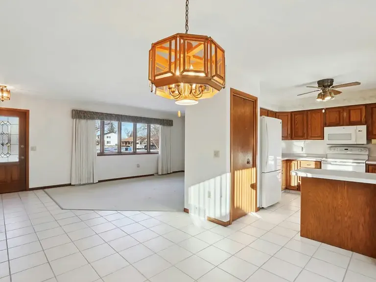 Dining room, kitchen, living room. Light fixtures have been updated.