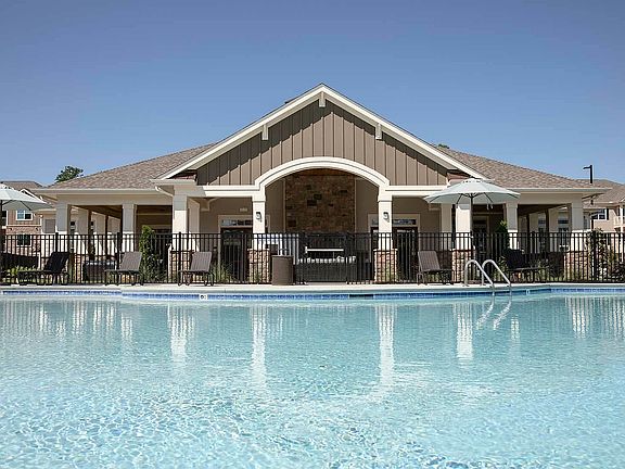 Experience resort-style living with luxurious amenities and a pristine pool.