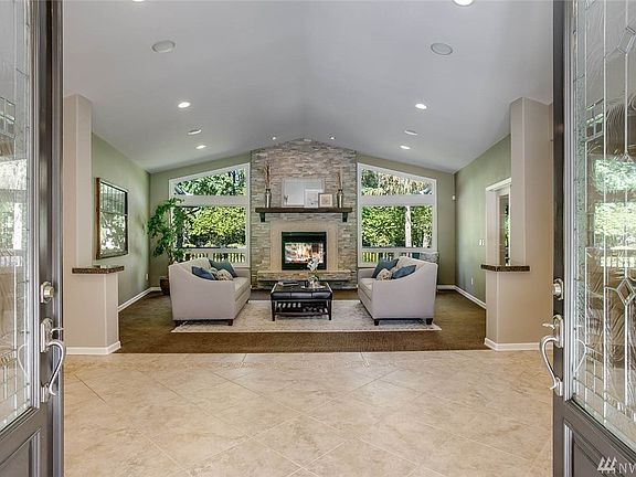 Enter to a wide tile foyer looking into the living room. Sonos sound system streams music to 6 rooms for everyday use or entertaining.
