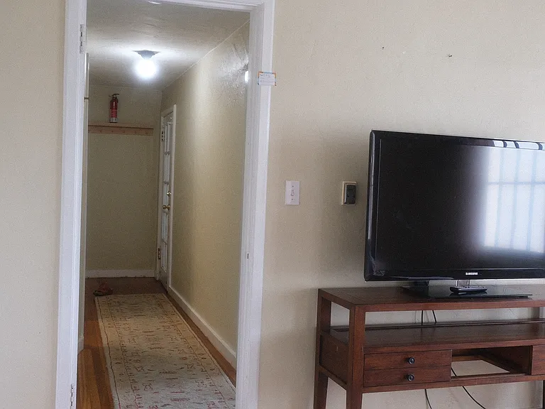 view from the living room to the hallway. The bedroom is off to the right from the hallway