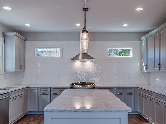 Kitchen with Marble-Quartz Countertops and Stainless Steel appliances with plenty of storage and a large island
