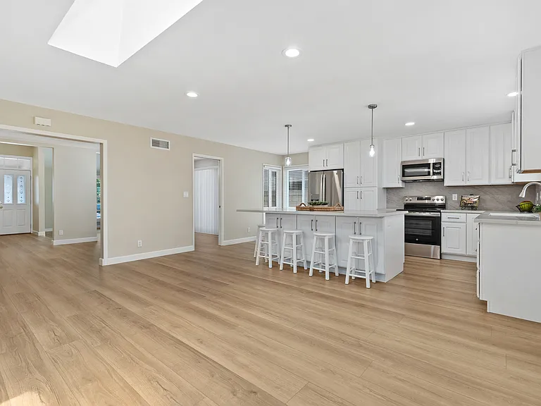 Open concept with Family Room and brand new Kitchen~with large quartz island and bar seating