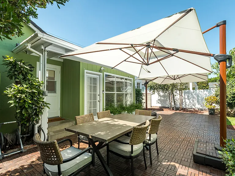 Private backyard retreat featuring a large patio for dining and entertaining, plus a lush lawn for play and relaxation.