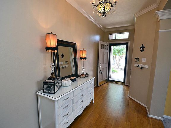 Beautiful foyer entry with hardwood floors, great space and gorgeous chandelier.