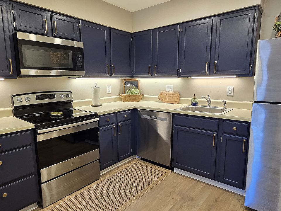 Stylish kitchen with rich navy cabinets, stainless steel appliances, and a practical layout for everyday cooking and entertaining. Brand-new countertops and sink installed since photos were taken.