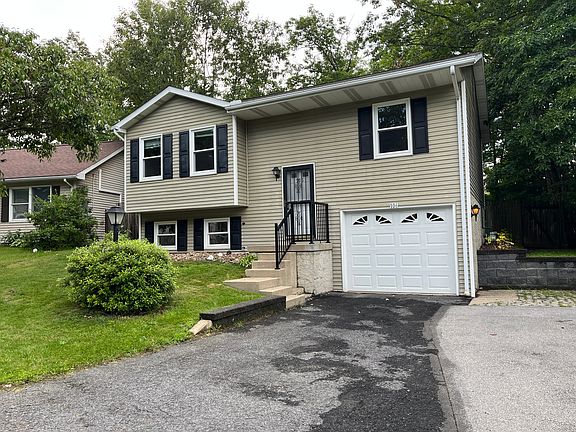 One car garage with parking for two more cars.