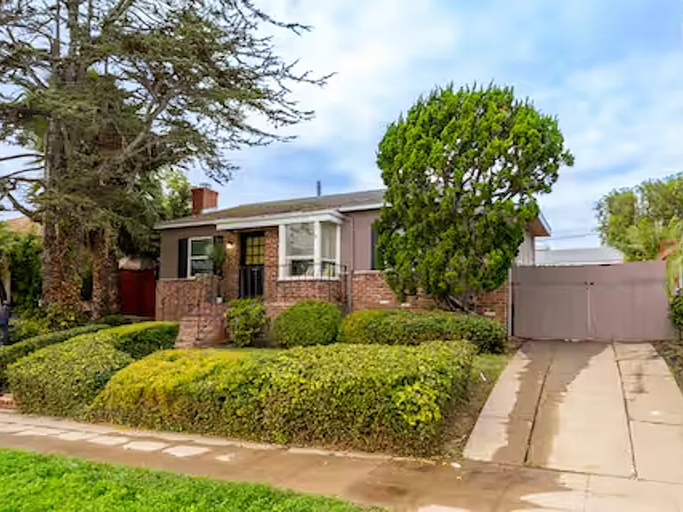 Charming coastal exterior set in a quiet Pacific Beach neighborhood with convenient tandem parking for up to 3 vehicles in the driveway.