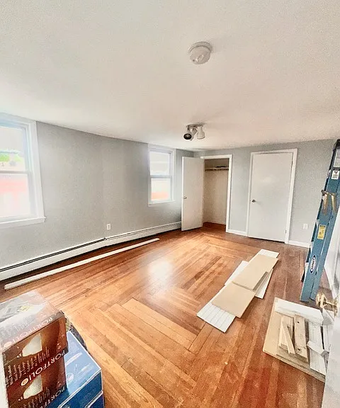 bedroom on main level with hardwood flooring