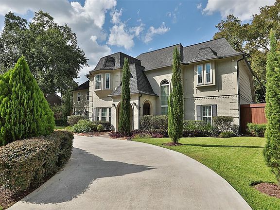 SOPHISTICATED AND TIMELESS DESCRIBES THIS HOMES CURB APPEAL - This fabulous light-grey painted brick with dark grey shutters and trim welcomes warm energy! Professionally landscaped both front and back with full sprinkler system. Highly maintained by