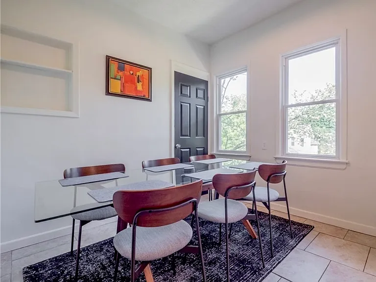 Dining room off of the kitchen. Door leads to walk-in pantry.