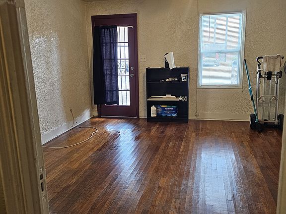 Living room from the kitchen toward front door.