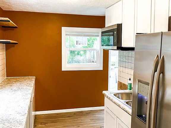 New stainless steel appliances. Gas range, above the range microwave, side by side fridge with ice maker and water