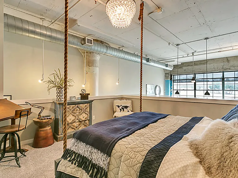 Loft style bedroom with carpet