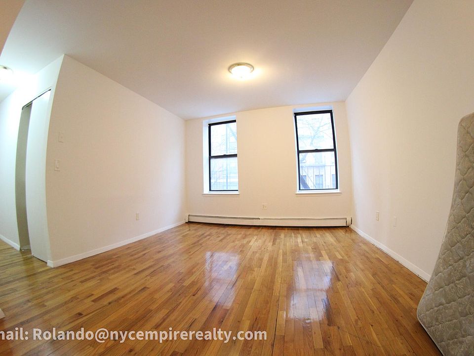 Living room with polished hardwood floors. Mattress will be removed.