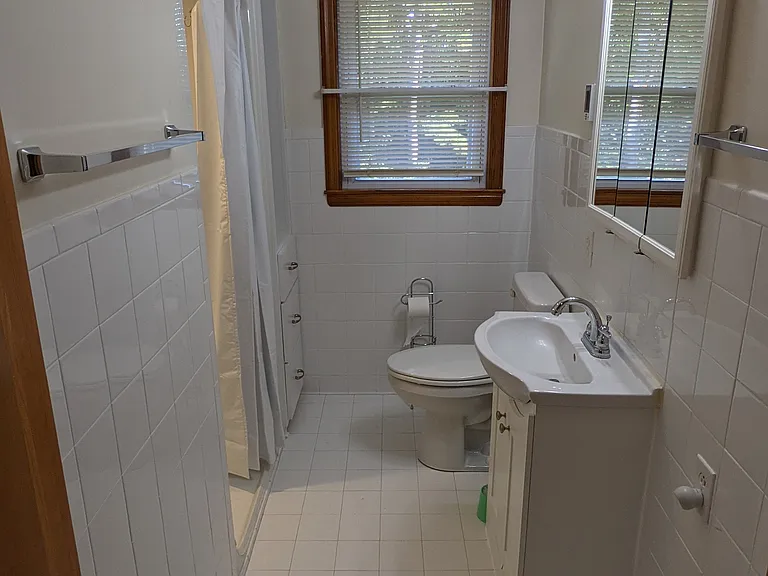 Upstairs full bathroom includes easy step-in shower.