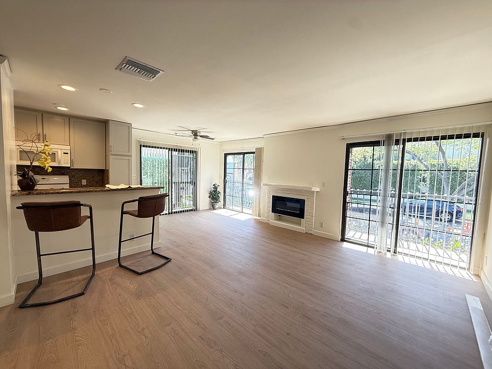 Living Room/Dining Area with 2 BALCONIES off the front of the building. Electric fireplace