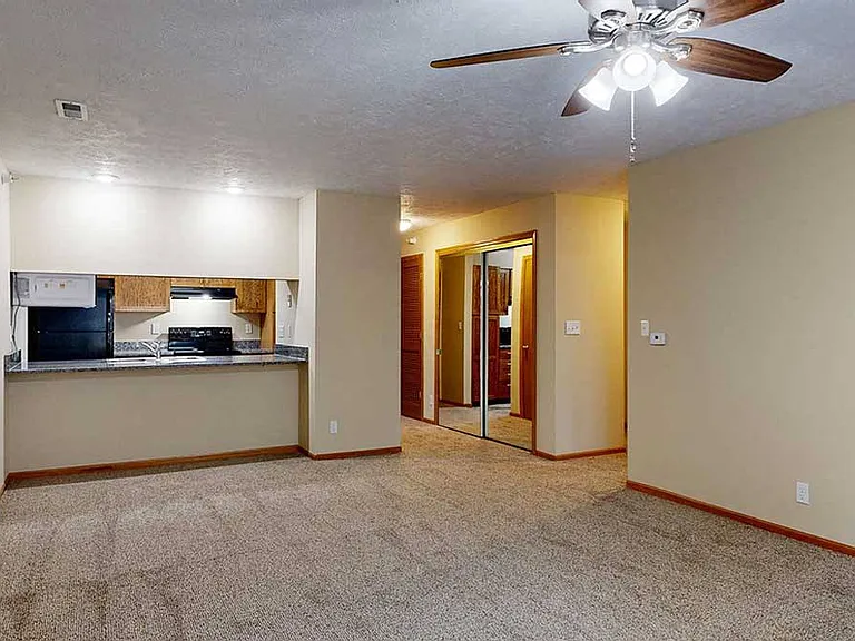 Our Imperial floorplan offers an open living room and dining area, complemented by a kitchen bar countertop.