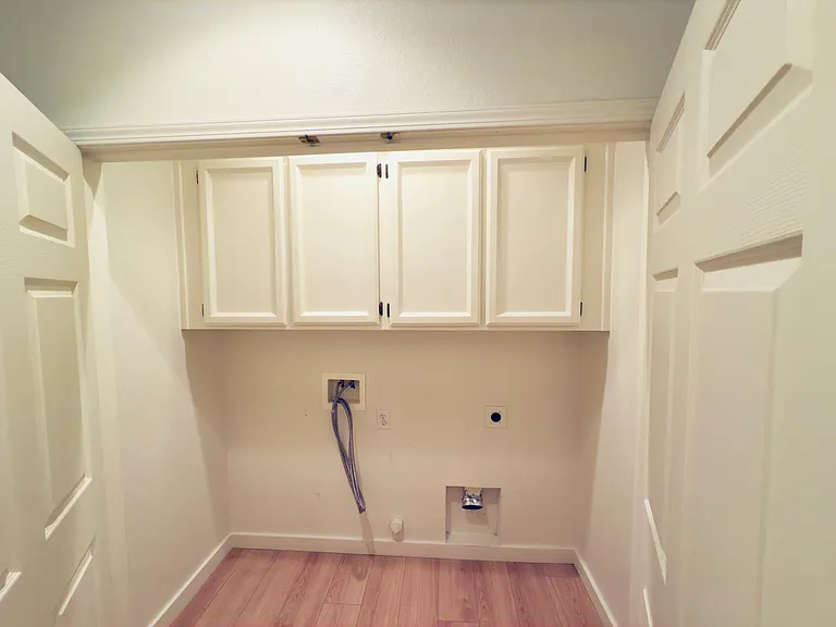 Convenient laundry area with washer and dryer hookups, plus built-in cabinets for extra storage and organization!