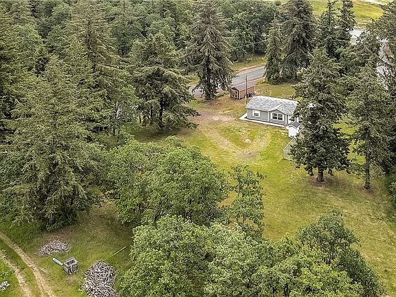 Drone shot of your property, bordered by two roads (corner lot) and a neighbor bottom left. 