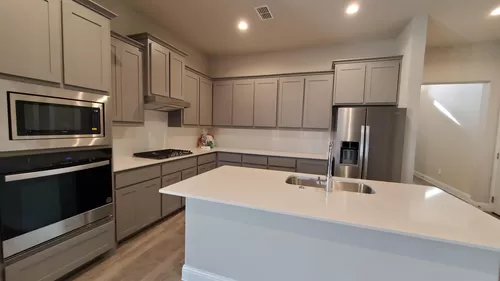 Spacious kitchen with Cesar counter tops, beautiful backsplash and fine kitchen cabinets. All new Whirlpool refrigerator, microwave and baking oven. - 3041 Lionsgate Dr