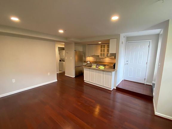 Living room into kitchen and peak into hallway