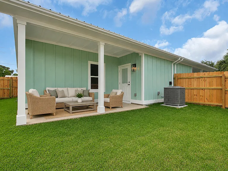 Private fenced yard and back porch

This image has been virtually staged.